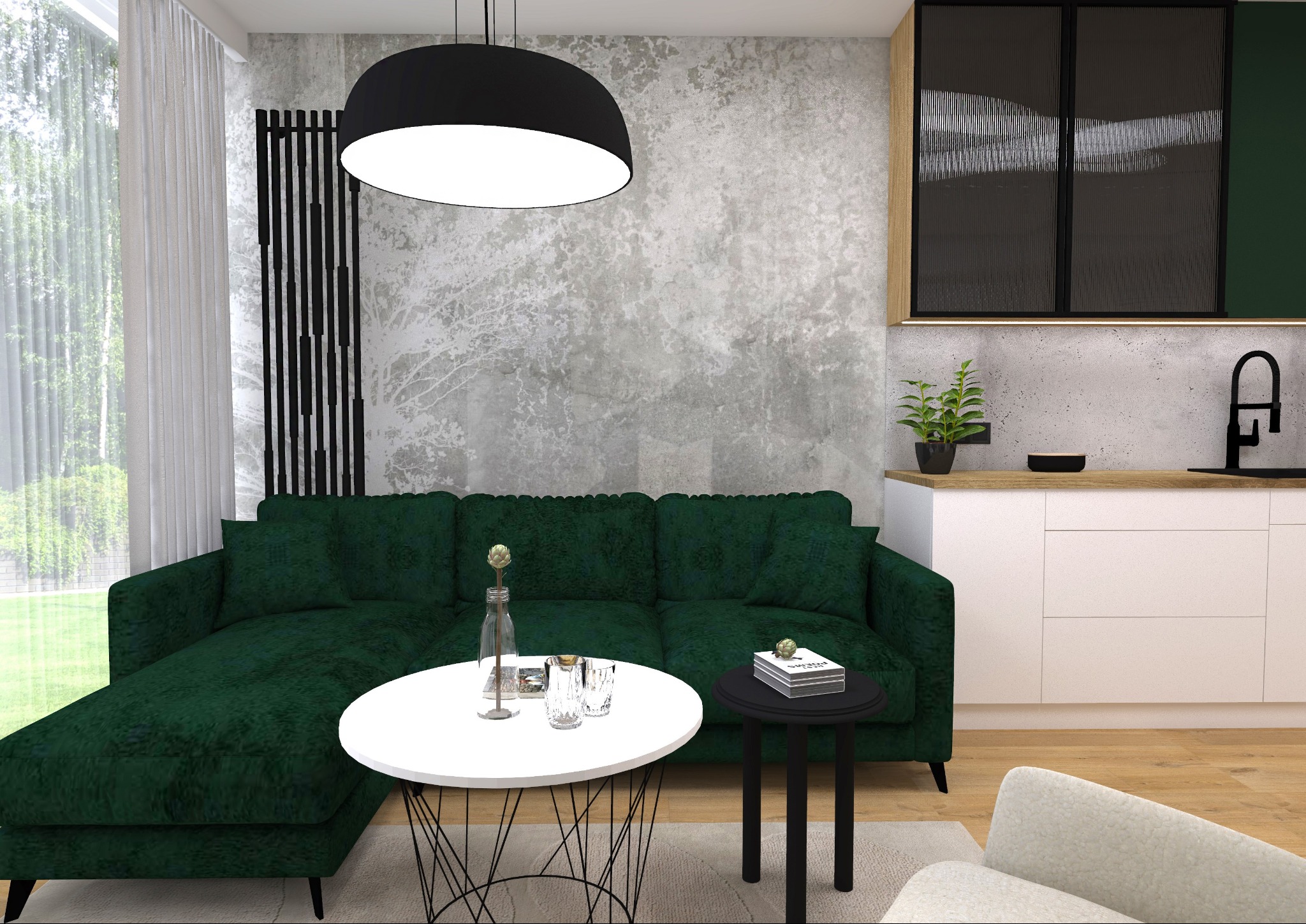 Wnętrze salonu z zieloną sofą narożną, okrągłym białym stolikiem kawowym z drucianą podstawą, czarnym stolikiem pomocniczym, szarą ścianą z efektem betonu i elementami kuchni w tle.