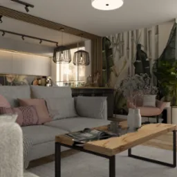 Jasny salon z szarą sofą, drewnianym stolikiem kawowym z czarną ramą, lampami wiszącymi w stylu industrialnym i tapetą w motywy roślinne za sofą. W tle widoczna kuchnia z białymi szafkami...