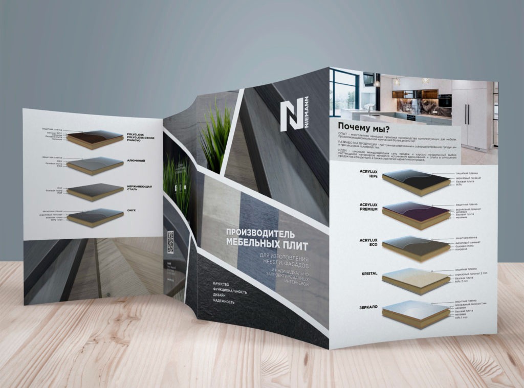 Rozłożona ulotka reklamowa producenta płyt meblowych Niemann, prezentująca różne warianty wykończeń i tekstury, z widocznymi przekrojami warstw materiałów oraz aranżacją kuchni w tle.