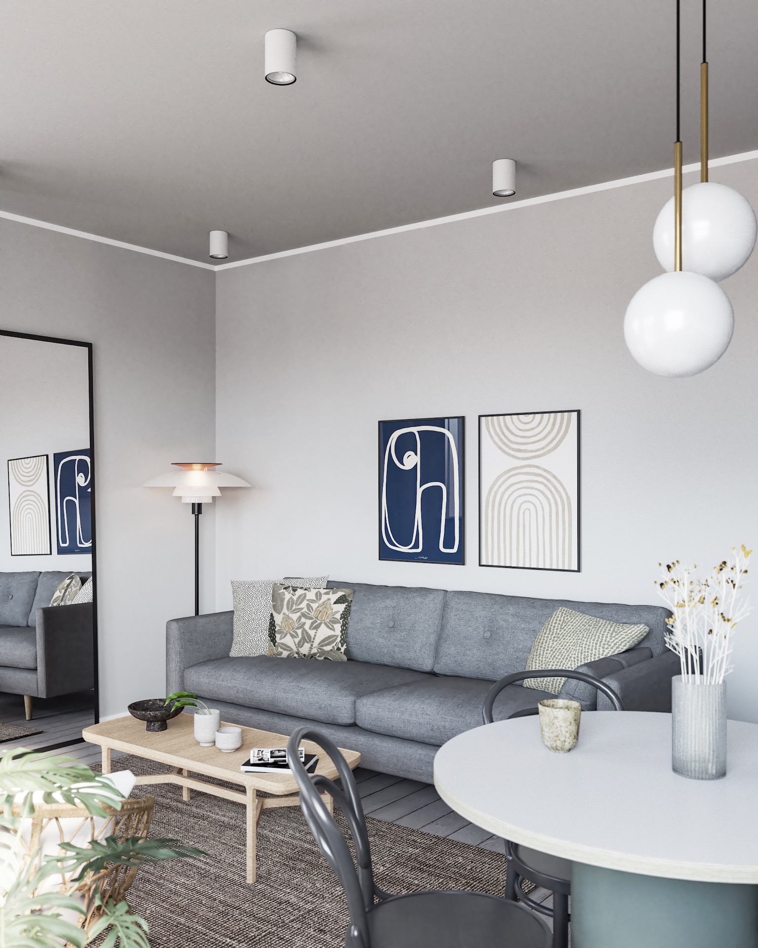 Nowoczesny salon z szarą sofą, drewnianym stolikiem, okrągłym stołem i minimalistycznymi plakatami na ścianie. Oświetlenie punktowe i lampa podłogowa dopełniają aranżację.