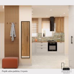 Karolina Rzeczkowska - Nowoczesna kuchnia z drewnianymi szafkami, czarnym okapem i wzorzystą mozaiką nad blatem, widok z przedpokoju z drewnianym panelem ściennym, wieszakami i pomarańczowym pufem.