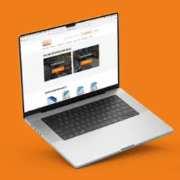 Ekran laptopa prezentuje stronę internetową sklepu budowlanego Gluc.com.pl, z widocznymi kategoriami 'Nasze Składy' i 'Betoniarnia' oraz popularnymi produktami. Interfejs strony jest responsywny...