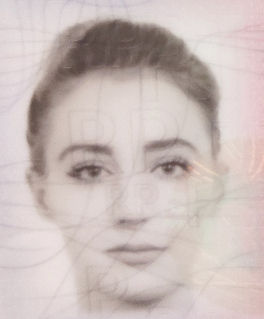 Portret kobiety z nałożonymi, ledwo widocznymi liniami i znakami wodnymi, przypominający zdjęcie do dokumentów.