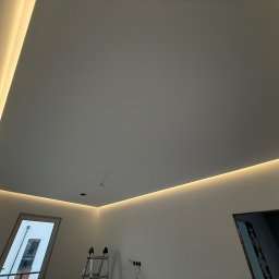 CleverHouse Paweł Piotrowski - Nowoczesne oświetlenie sufitowe LED w kształcie kwadratu, z drabinką w rogu pokoju. Minimalistyczny design, ciepłe światło.