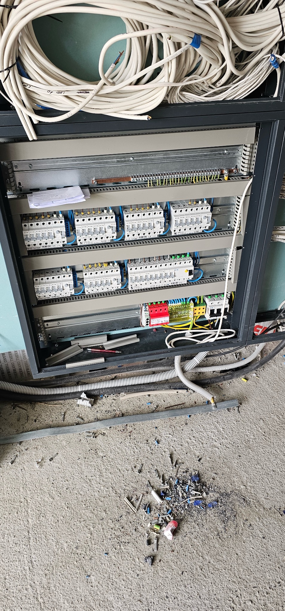 Rozdzielnia elektryczna z zabezpieczeniami i przewodami w Gliwicach. Widoczne kable, bezpieczniki i elementy montażowe. Instalacja w trakcie prac.