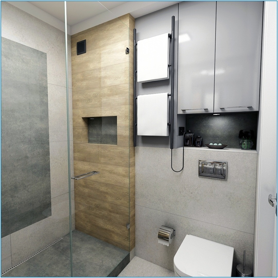 Wnętrze nowoczesnej łazienki z kabiną prysznicową wyłożoną szarą płytką, drewnopodobną ścianą z wnęką, grzejnikiem drabinkowym z białymi ręcznikami, szarą szafką wiszącą i podwieszaną toaletą.