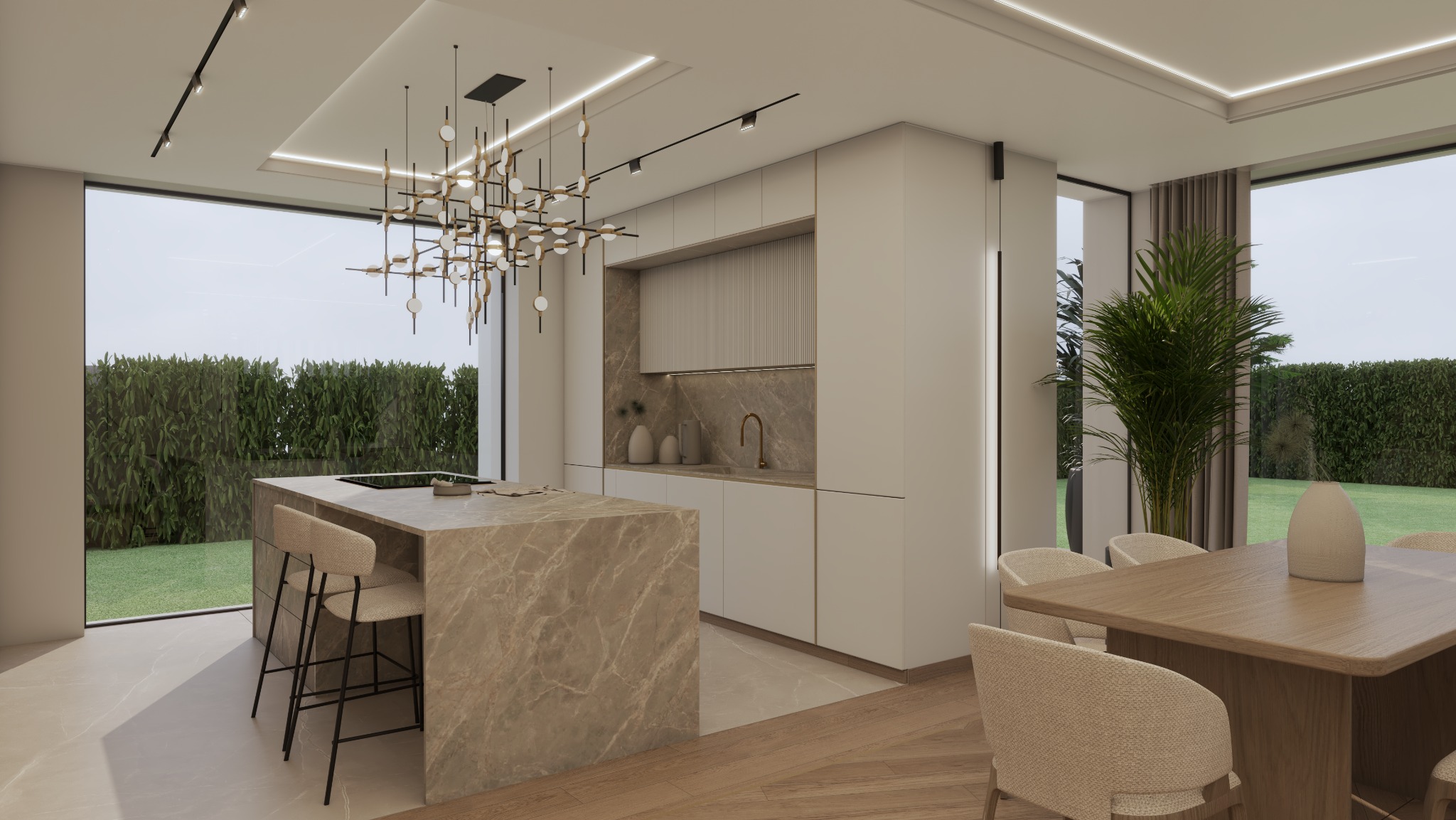 Elegancka kuchnia z wyspą z marmuru, oświetlona nowoczesną lampą wiszącą. W tle widoczne okno z zielenią i stół jadalny z krzesłami w stonowanych barwach.