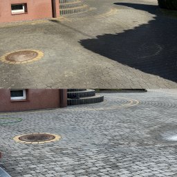 Adam Skrzydliński AdMal - Szara kostka brukowa ułożona w łuki, z widocznym włazem kanalizacyjnym otoczonym żółtą kostką i fragmentem elewacji budynku w tle.