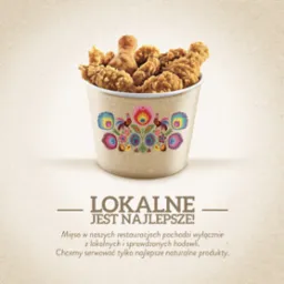 Kubełek z kurczakiem KFC ozdobiony motywami ludowymi, hasło 'Lokalne jest najlepsze!'