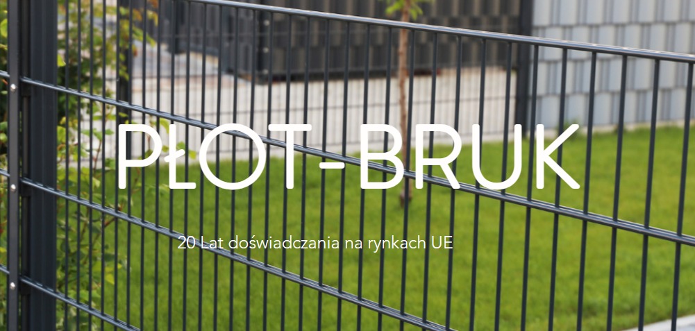 Zdjęcie prezentuje fragment ogrodzenia panelowego w kolorze grafitowym, z tekstem 'PŁOT-BRUK' i informacją '20 Lat doświadczania na rynkach UE' nałożonym na obraz. W tle widoczny trawnik i budynek.