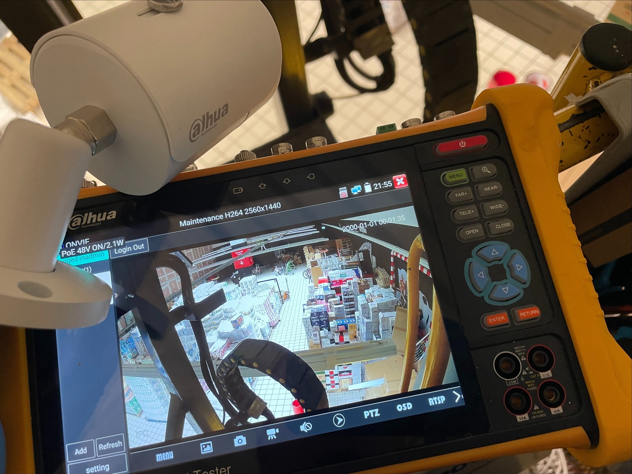 Tester instalacji kamer Dahua z podglądem obrazu z kamery monitoringu w sklepie, widoczna biała kamera IP Dahua