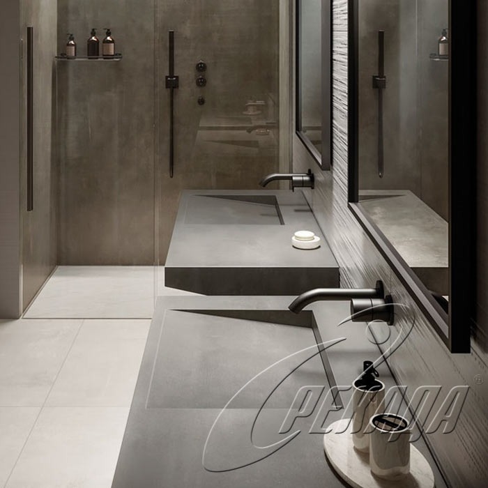 Nowoczesna łazienka z dwoma betonowymi umywalkami w kolorze grafitowym, czarne baterie, minimalistyczne lustra i szklana kabina prysznicowa w tle.