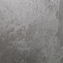 Szara, teksturowana powierzchnia z efektem mikrocementu, ukazująca nieregularne wzory i subtelne refleksy światła.