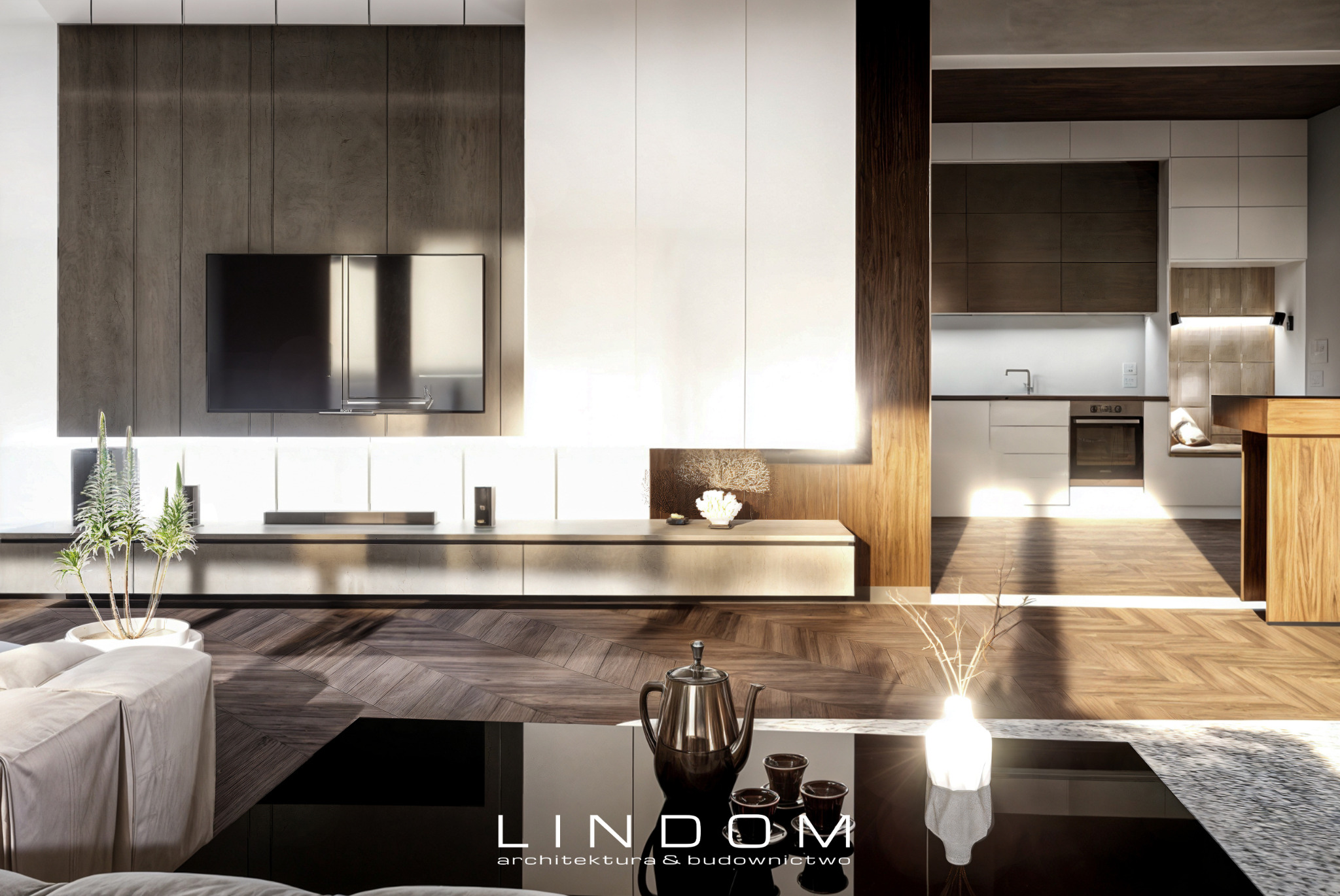 Wnętrze nowoczesnego salonu z parkietem w jodełkę, telewizorem na ścianie z okładziną imitującą drewno, białymi szafkami pod telewizorem, antresolą i widokiem na kuchnię z drewnianymi elementami.