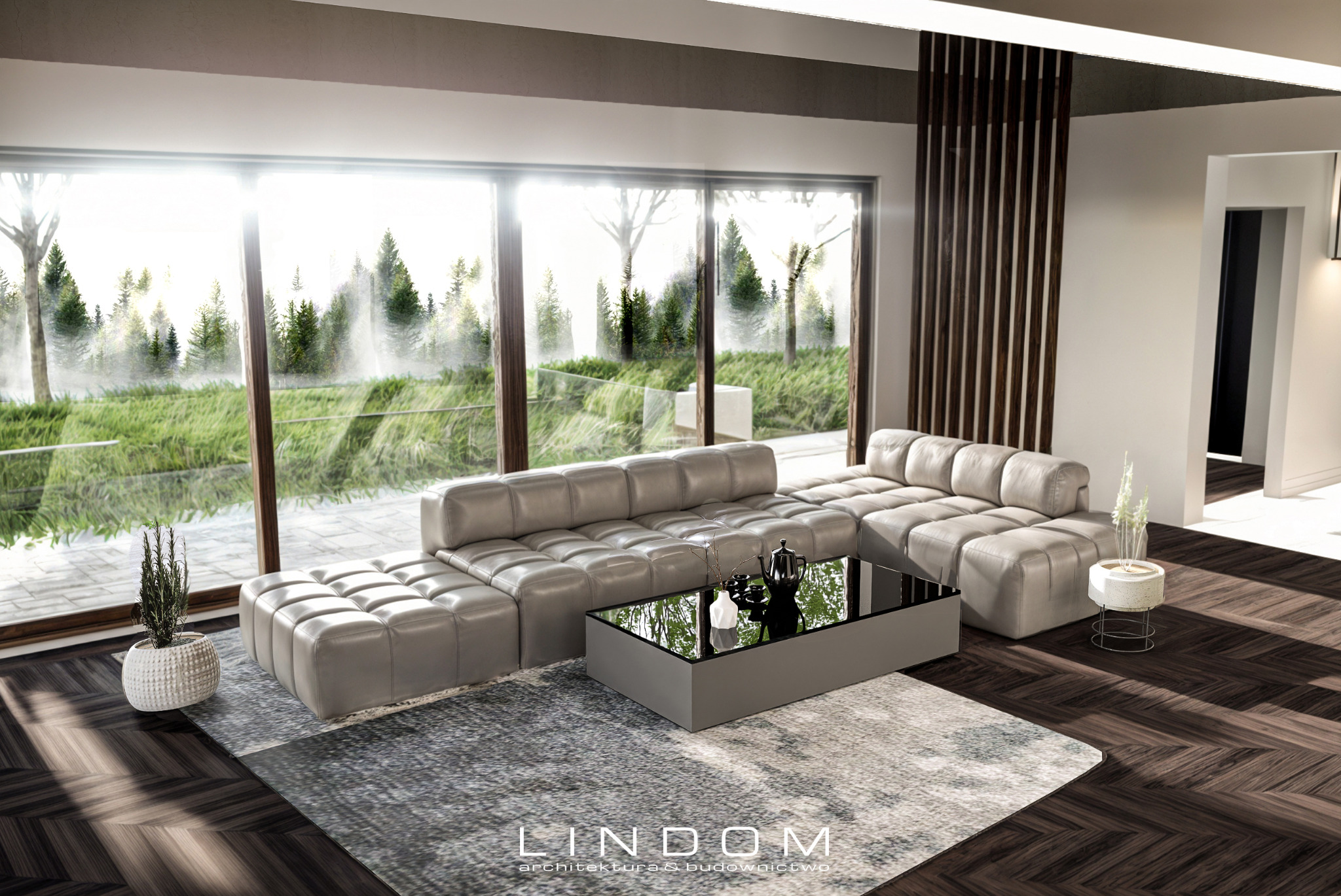 Wnętrze domu jednorodzinnego: modułowa sofa w odcieniach szarości, szklany stolik kawowy z czarnymi akcentami, widok na zieleń przez panoramiczne okno, parkiet ułożony w jodełkę.