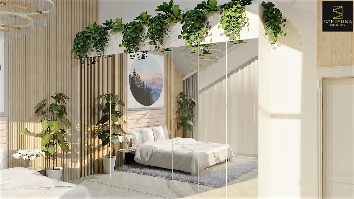 Jasna sypialnia z łóżkiem w białej pościeli, drewnianą ścianą z pionowymi panelami, roślinami doniczkowymi oraz lustrem odbijającym wnętrze, okrągły obraz z motywem górskim.