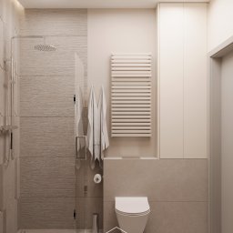 Autorska Pracownia Architektury i Wnętrz Gabriela Radwanowska - Nowoczesna łazienka w beżowych odcieniach z kabiną prysznicową typu walk-in, grzejnikiem drabinkowym, wiszącą toaletą i ukrytą szafką nad nią.