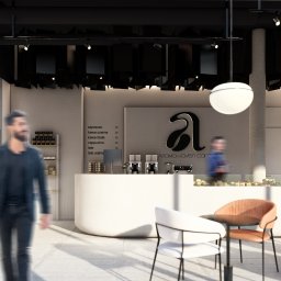 ASthetic form - Wnętrze kawiarni z ladą, menu kaw, ekspresami, ciastami w witrynie, stolikami z krzesłami i przechodzącym mężczyzną w casualowym stroju.