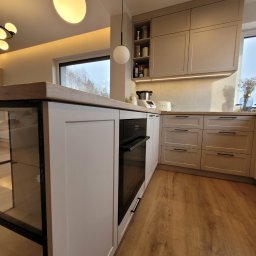 Serce domu w nowoczesnym wydaniu
Jasna, przestronna kuchnia łącząca nowoczesną elegancję z przytulnym klimatem. Stonowane, jasne fronty idealnie współgrają z drewnianymi blatami. Duża wyspa kuchenna to idealne miejsce na poranną kawę