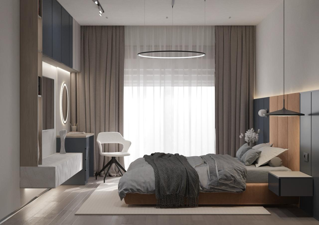 Nowoczesna sypialnia z biurkiem i toaletką, szaro-beżowa kolorystyka, okrągła lampa wisząca, dekoracyjna narzuta w jodełkę.