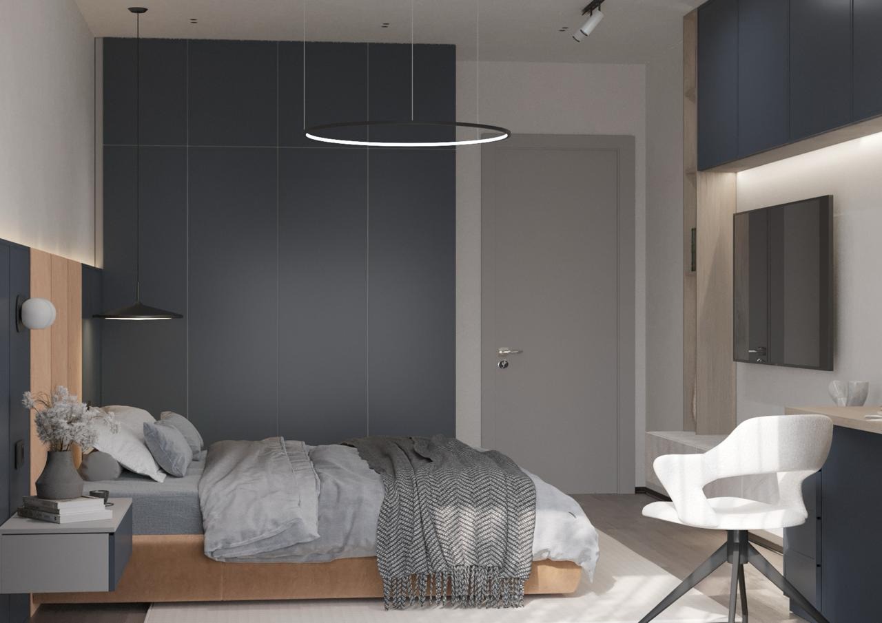 Nowoczesna sypialnia w odcieniach szarości i granatu z okrągłą lampą sufitową, minimalistycznym stolikiem nocnym i dekoracyjnym pledem w jodełkę.
