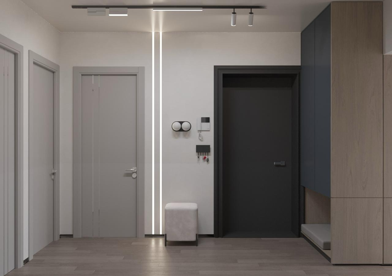 Nowoczesny przedpokój z trzema drzwiami w odcieniach szarości, podświetlaną pionową linią LED, minimalistycznym siedziskiem i szafą w zabudowie z elementami drewna i granatu.