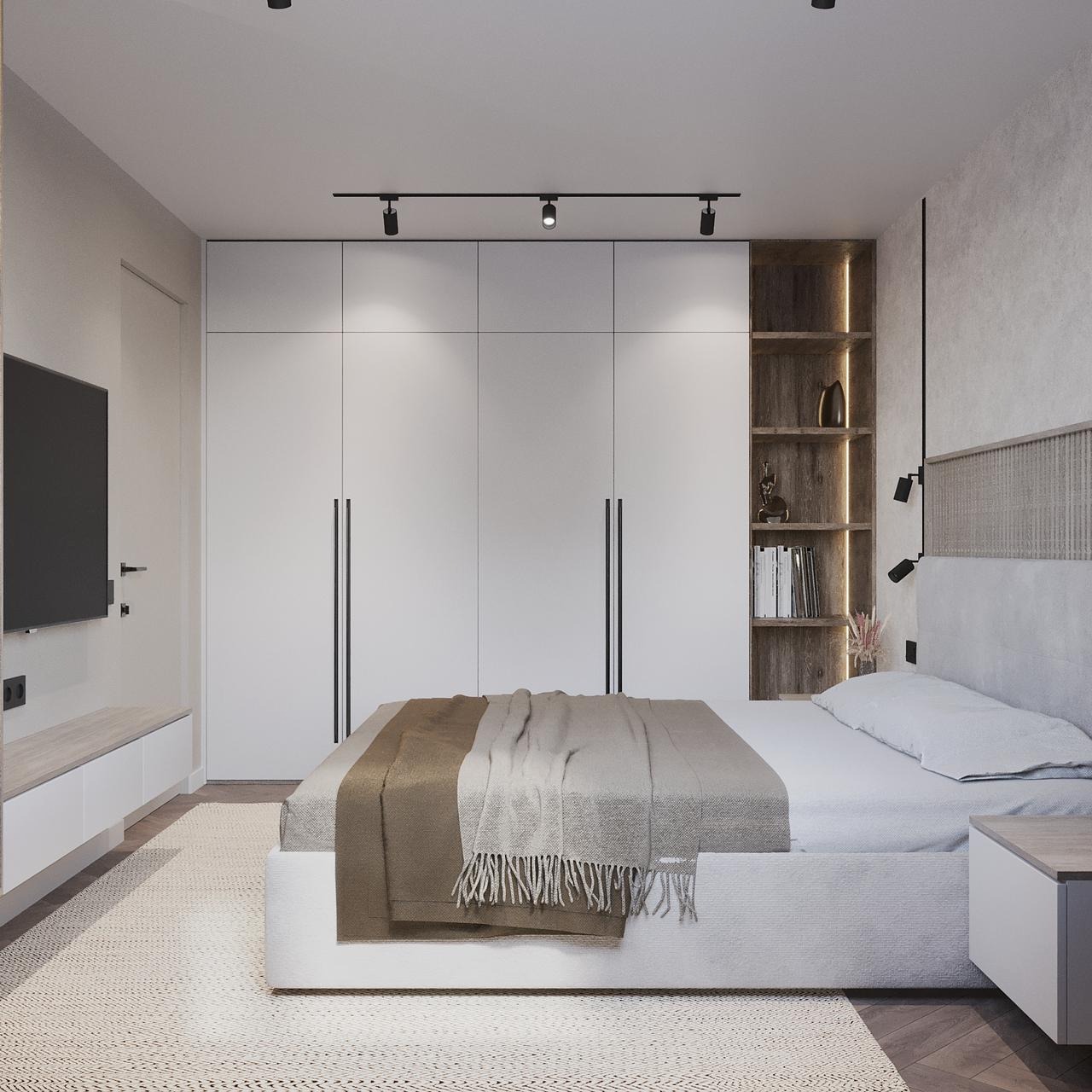 Nowoczesna sypialnia z dużym białym łóżkiem, szafą w zabudowie i drewnianym regałem z podświetleniem, minimalistyczne oświetlenie szynowe na suficie, dywan z geometrycznym wzorem.