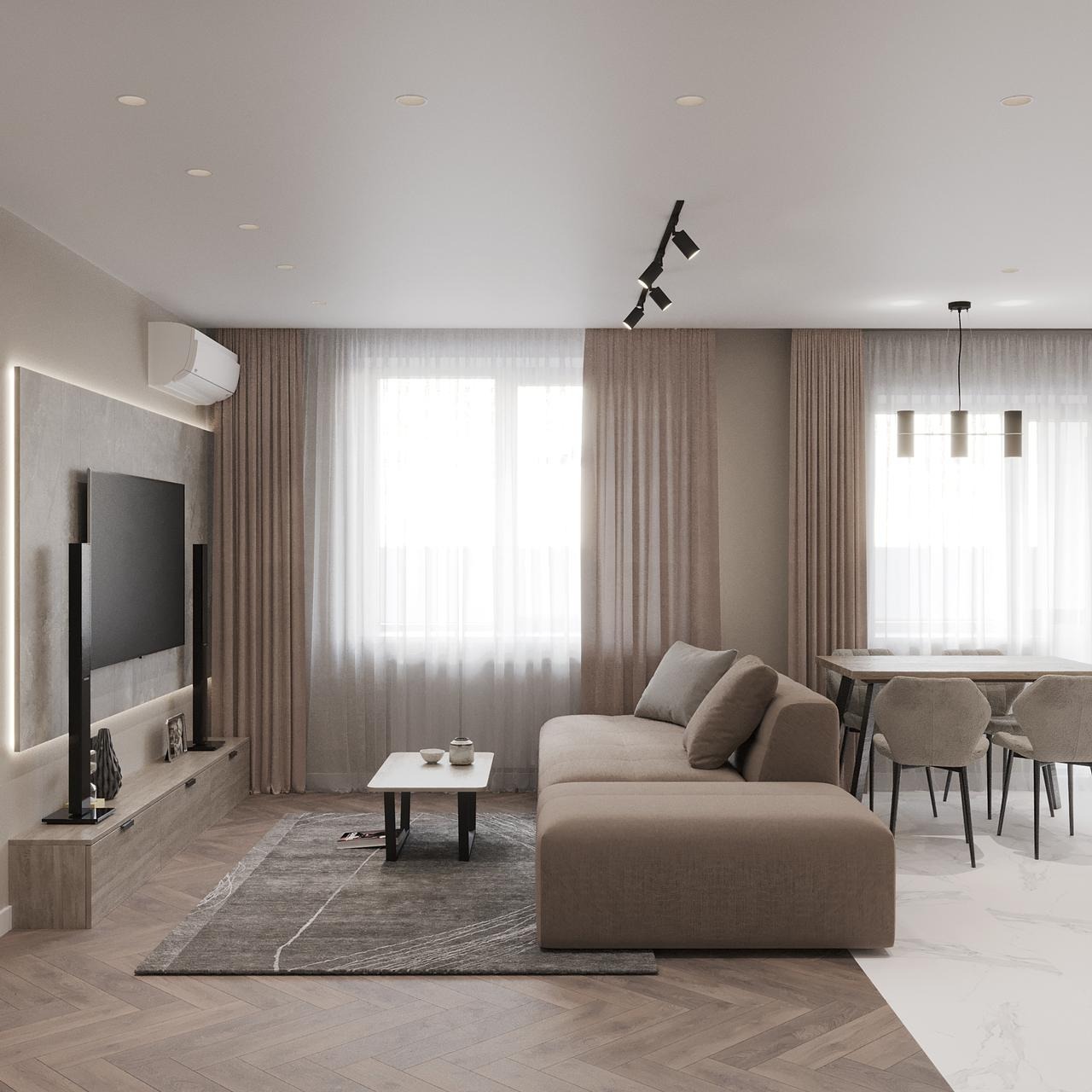 Jasne wnętrze salonu z beżową sofą, stolikiem kawowym, dywanem w geometryczne wzory i telewizorem na ścianie z podświetleniem LED, widok na stół jadalny z krzesłami w tle.