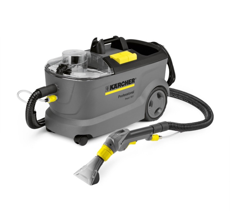 Profesjonalny odkurzacz piorący Kärcher Puzzi 10/1, wykorzystywany w Poznaniu do czyszczenia tapicerki meblowej i dywanów, widoczny na białym tle. Urządzenie ma szarą obudowę z żółtymi akcentami...