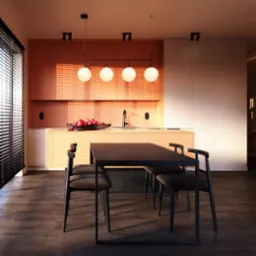 Nowoczesna kuchnia z pomarańczowymi szafkami, czarnym stołem i krzesłami. Na blacie misa z owocami. Światło słoneczne wpada przez żaluzje, tworząc ciepłą atmosferę.