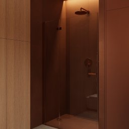 Jacek Gonera - Studio Projektowania Architektury Wnętrz - Minimalistyczna kabina prysznicowa z brązowego szkła i armaturą w odcieniach miedzi, podświetlona ciepłym światłem, w nowoczesnej łazience.