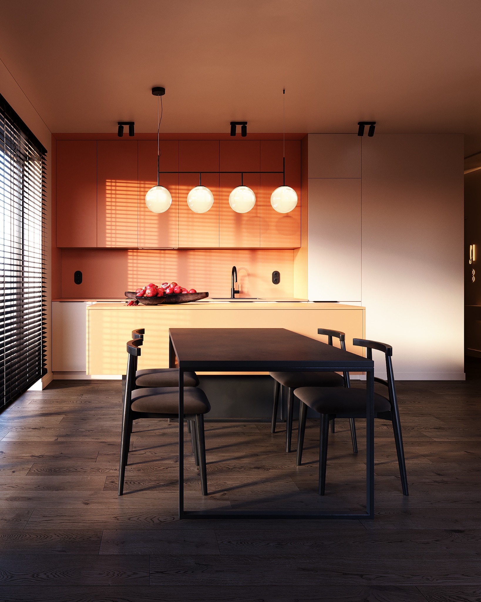 Nowoczesna kuchnia z pomarańczowymi szafkami, czarnym stołem i krzesłami. Na blacie misa z owocami. Światło słoneczne wpada przez żaluzje, tworząc ciepłą atmosferę.