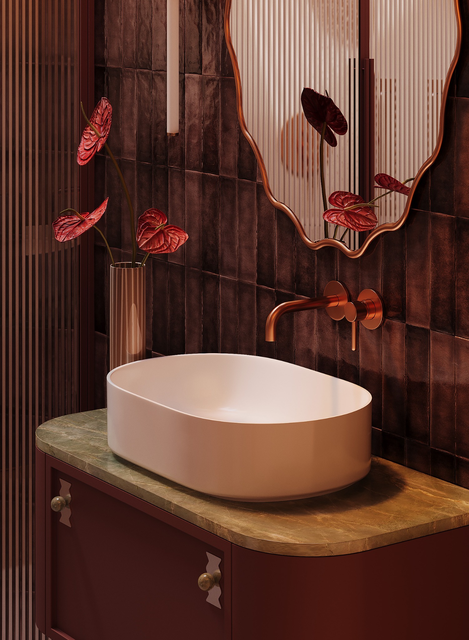 Stylowa łazienka z owalną umywalką na szafce z marmurowym blatem, brązowe płytki na ścianie, lustro z falistą ramą i kwiaty anturium w wazonie.