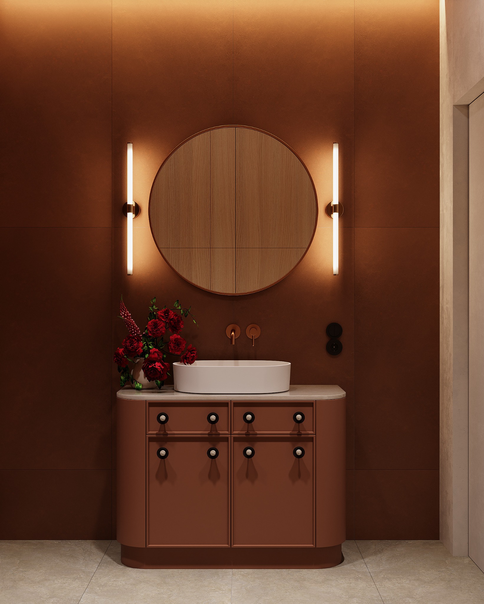 Nowoczesna łazienka w odcieniach terakoty z okrągłym lustrem podświetlonym listwami LED, umywalką nablatową i kwiatami w wazonie.