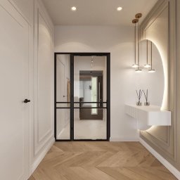 Wawrzyniak Karol - Nowoczesny przedpokój z drewnianą podłogą w jodełkę, przeszklonymi drzwiami z czarnymi szprosami, białymi szafami w zabudowie, konsolą z oświetleniem LED i wiszącymi lampami w kolorze złotym.