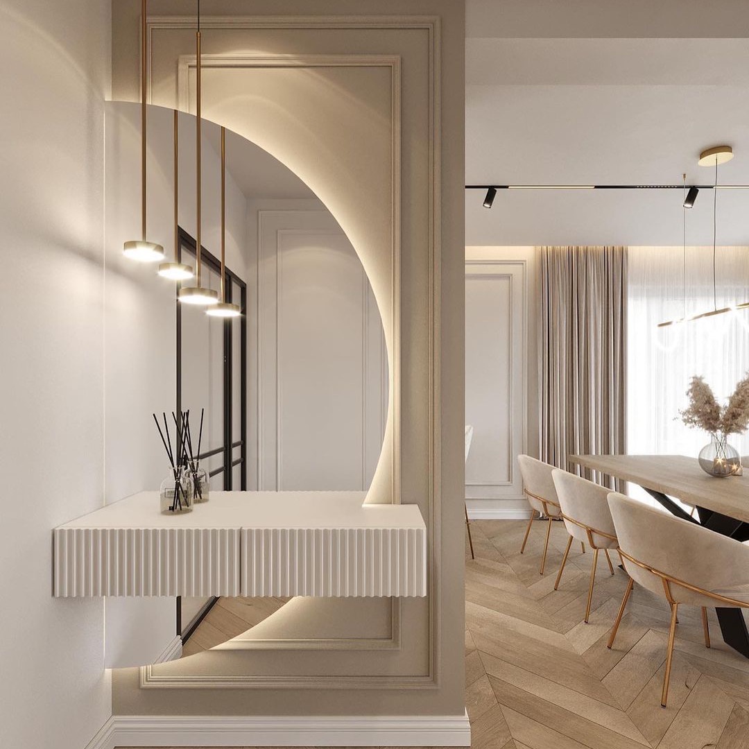 Nowoczesny przedpokój z półokrągłym lustrem podświetlonym LED, wiszącą konsolą z ryflowanym frontem, zapachowymi patyczkami i widokiem na jadalnię z parkietem w jodełkę.