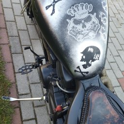 Zrób to sam - Motocykl z aerografem na baku przedstawiającym czaszki i napisy, skórzane siodło z ozdobnym obszyciem, nietypowe podnóżki w kształcie kastetu