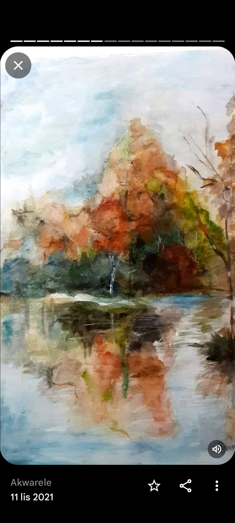 Akwarel przedstawia jesienny krajobraz z drzewami o czerwono-pomarańczowych liściach odbijającymi się w tafli jeziora, z widocznymi pociągnięciami pędzla i subtelnymi przejściami kolorystycznymi.