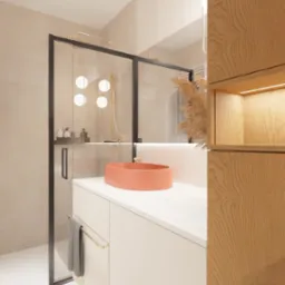 Nowoczesna łazienka z kabiną prysznicową typu walk-in, umywalką w kolorze koralowym i drewnianą zabudową z podświetlaną wnęką, widoczny ręcznik na relingu i designerska bateria.
