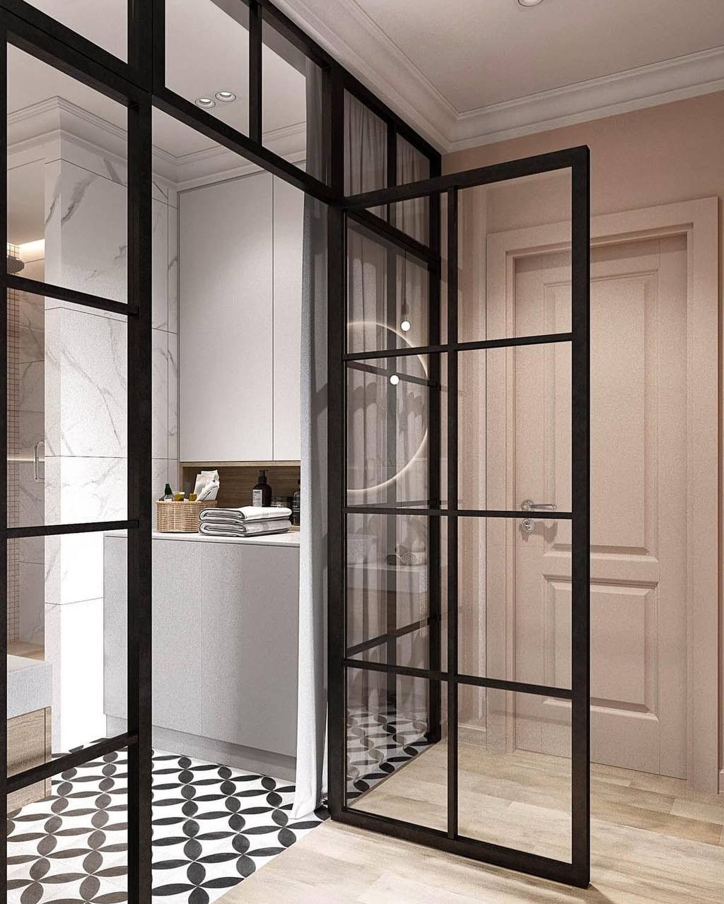 Czarne, przeszklone drzwi w stylu industrialnym, otwarte do wnętrza łazienki z białą marmurową ścianą i wzorzystą podłogą.
