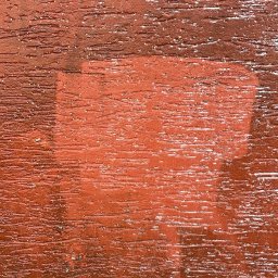 Krystian Jakubowski - Fragment pomalowanej, teksturowanej, brązowo-czerwonej powierzchni z widocznymi śladami pędzla i jaśniejszym prostokątnym obszarem, sugerującym niedokładne krycie farbą.