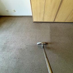 Pan do Plam Kompleksowo dla Czystości Artur Janiec - Pranie dywanu w biurze: fragment wyczyszczonego dywanu z widoczną różnicą w kolorze i urządzenie do prania dywanów z metalową rączką.