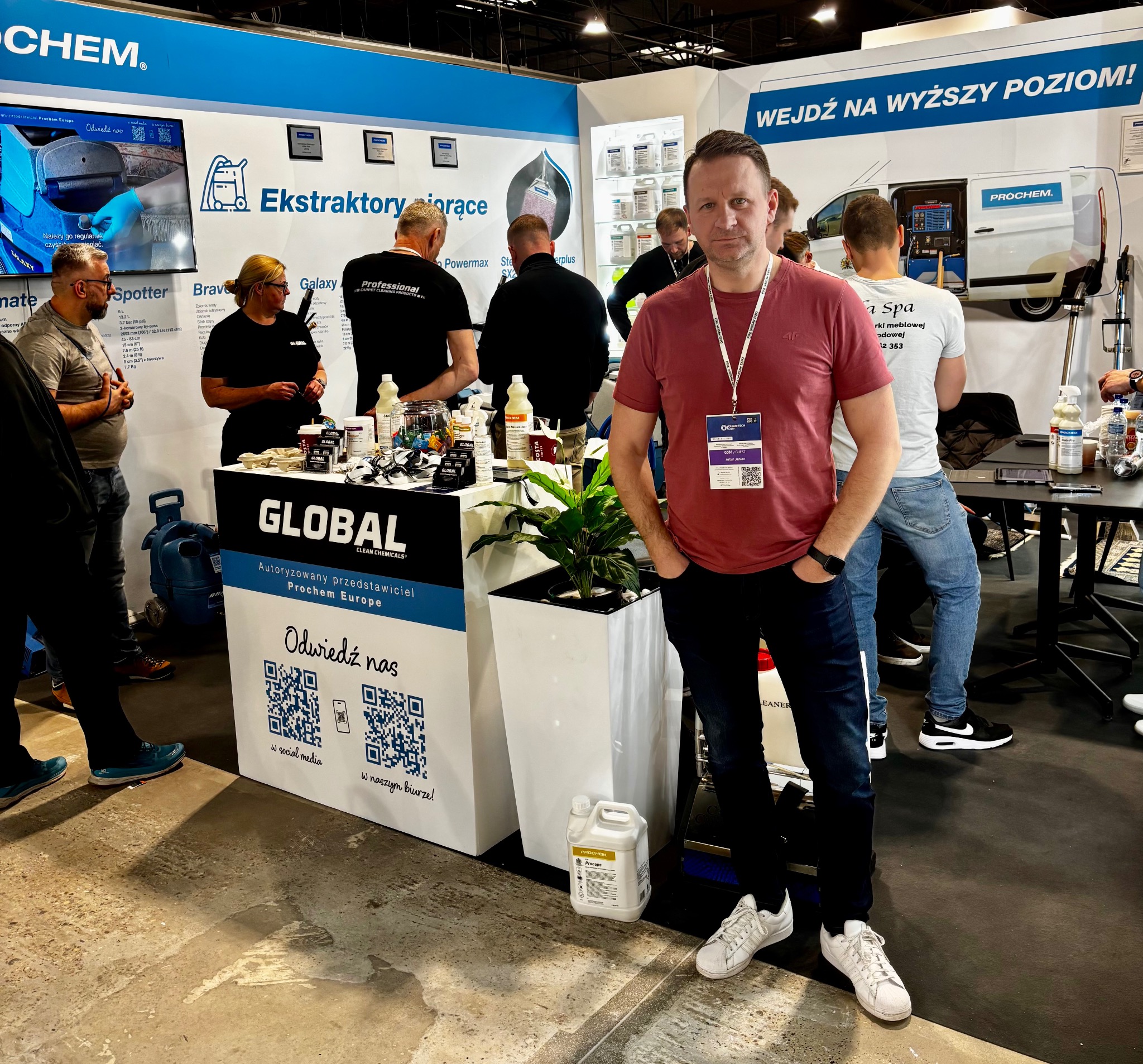Stoisko firmy Prochem na targach z ekspozycją ekstraktorów i chemii do czyszczenia. W tle pracownicy, na pierwszym planie mężczyzna z identyfikatorem.