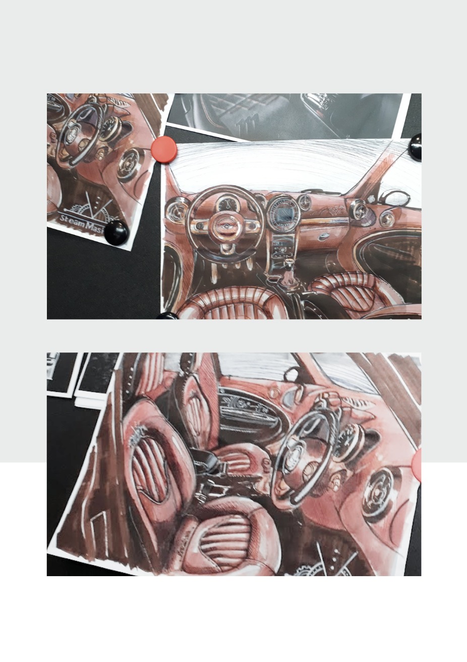 Ręcznie rysowane szkice wnętrza samochodu w stylu steampunk, przypięte do czarnej tablicy korkowej za pomocą kolorowych pinezek. Widoczne detale deski rozdzielczej i siedzeń.