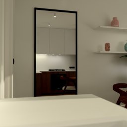 Jakub Pastuszka Kontur Wnętrz - Minimalistyczna kuchnia widoczna w lustrze, z drewnianym stołem i rośliną na pierwszym planie, oraz półkami z dekoracyjnymi wazonami na ścianie.