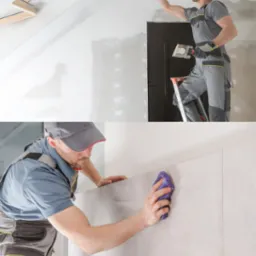 Mężczyzna w szarym kombinezonie stojący na drabinie szpachluje sufit, a na dole kadru pracownik czyści płytki na ścianie.