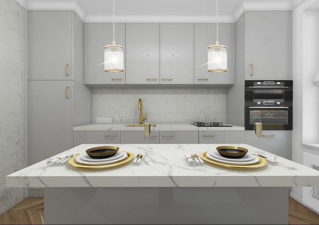 Elegancka kuchnia w odcieniach szarości z marmurowym blatem, złotymi akcentami w postaci baterii i dekoracyjnych lamp wiszących nad wyspą, nakryty stół dla dwóch osób.