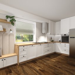 CONSTRUO - Jasna kuchnia z drewnianym blatem, białymi szafkami, siedziskiem z tapicerowanym oparciem i półkami na książki przy oknie, uzupełniona srebrną lodówką i drewnianą podłogą.