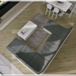 Widok z góry na salon z drewnianą podłogą, szarym narożnikiem, białym stolikiem kawowym z książką, dywanem i stołem z krzesłami, oświetlony naturalnym światłem z dużych okien.