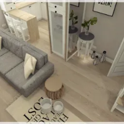 Wizualizacja jasnego salonu z szarą sofą, drewnianą podłogą i elementami dekoracyjnymi, widok z góry, uwzględniający fragment kuchni w tle.